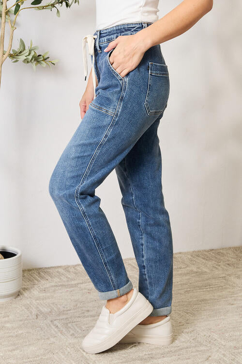 High Waist Drawstring Denim Jeans - Kawaii Stop - Adjustable Waist, Casual Chic, Chic Outfits, Comfortable Fit, Day-to-Night Wear, Denim Lover, Drawstring Denim, Fashion Forward, Fashionable, High Waist Jeans, Judy Blue, Must-Have, Quality Denim, Ship from USA, Styling Options, Stylish Jeans, Trendy, Versatile, Wardrobe Essential, Women's Jeans