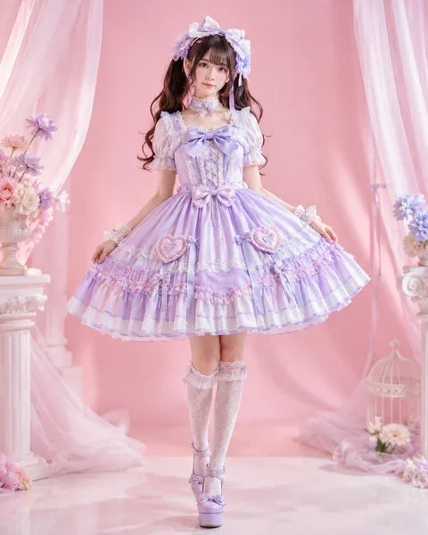Woman in a lavender Lolita dress with floral accessories against a pink background