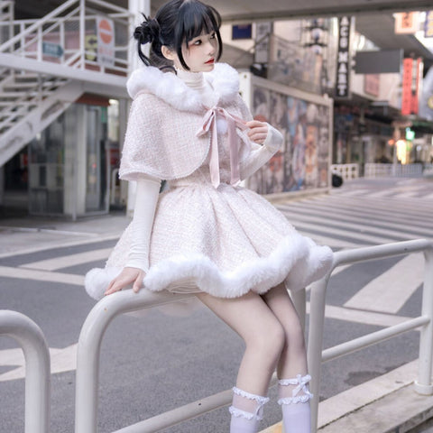 Pale pink hooded cape dress with white faux-fur trim and a pink ribbon bow