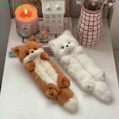 Brown and white plush fox zipper pencil cases displayed on a desk