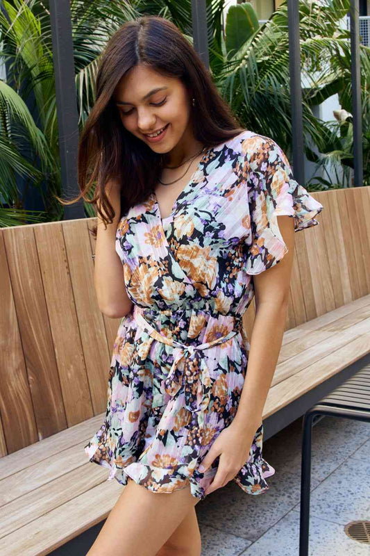 Full Size Floral Tie Belt Ruffled Romper - Kawaii Stop - California Fashion, Chic Apparel, Comfortable Romper, Floral Romper, Off-Season Mega Sale, Petal Dew, Petal Dew Clothing, Ruffle, Ship from USA, Short Sleeves, Summer Wardrobe, Surplice Neckline, Tie Belt, Trendy Outfit, Vacation Style, Women's Clothing